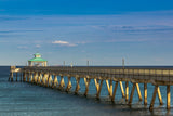 Long Ocean Pier in Sunlight and Blue Skies