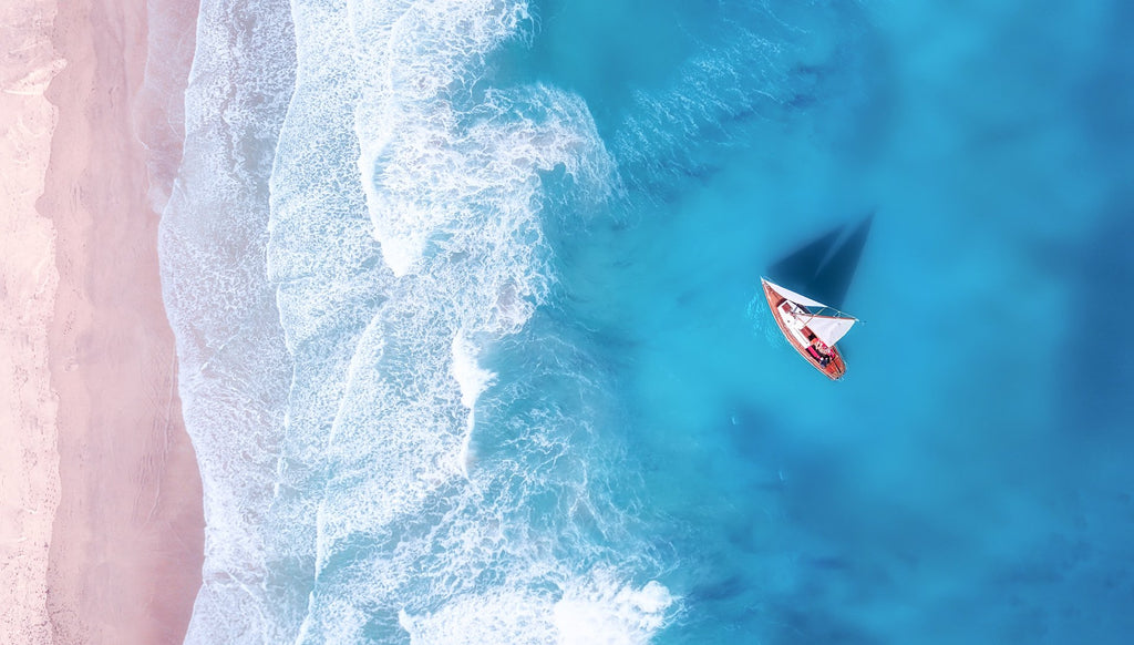 boat anchored off shore from above, beach, canvas art